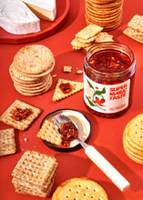 Load image into Gallery viewer, The midnight snack! Add Chili Crisp to your favourite snack spread - crackers + cheese, nachos, mixed with mayo as a dip - the list goes on (or you can always have a spoon or two straight from the jar if you're into that).